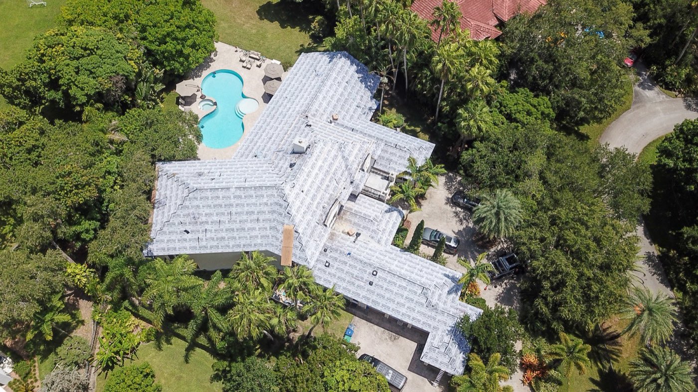 Aerial view of a Miami estate mid re-roof with fresh underlayment down